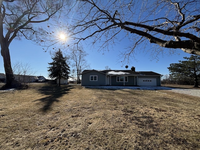 single story home with a garage and a front yard