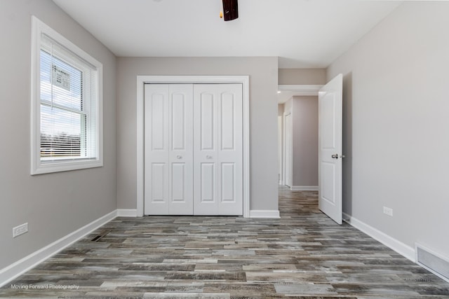 38W715 Huntley Rd, West Dundee, IL 60118 - unfurnished bedroom featuring a closet, wood finished floors, and a ceiling fan