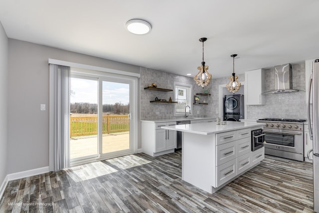 38W715 Huntley Rd, West Dundee, IL 60118 - kitchen with high end stainless steel range oven, wall chimney range hood, stacked washer / dryer, light countertops, and open shelves
