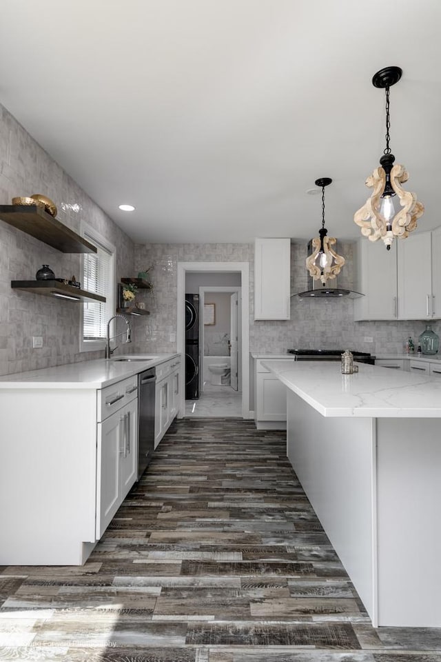 38W715 Huntley Rd, West Dundee, IL 60118 - kitchen with wall chimney range hood, dishwasher, open shelves, stacked washing machine and dryer, and white cabinetry