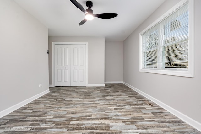 38W715 Huntley Rd, West Dundee, IL 60118 - unfurnished bedroom with wood finished floors, a closet, and a ceiling fan