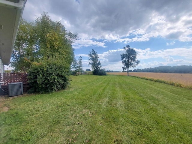 view of yard featuring a rural view and central AC