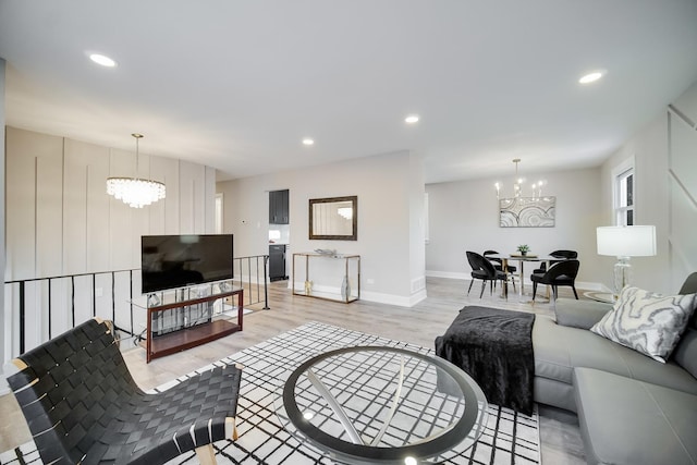 living room with a notable chandelier and light wood-type flooring