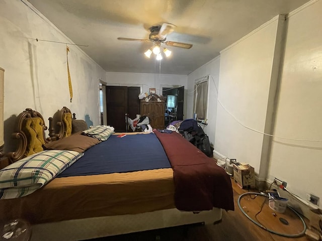 bedroom with ceiling fan and hardwood / wood-style flooring