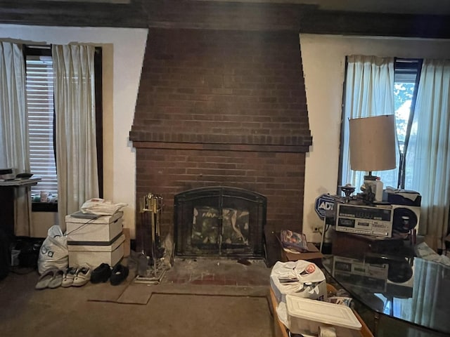 living area featuring a brick fireplace