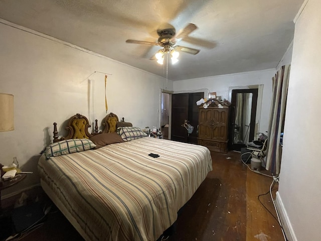 bedroom with ceiling fan and dark hardwood / wood-style flooring