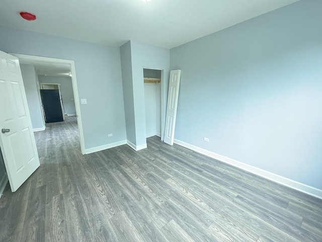 unfurnished bedroom featuring dark wood-type flooring