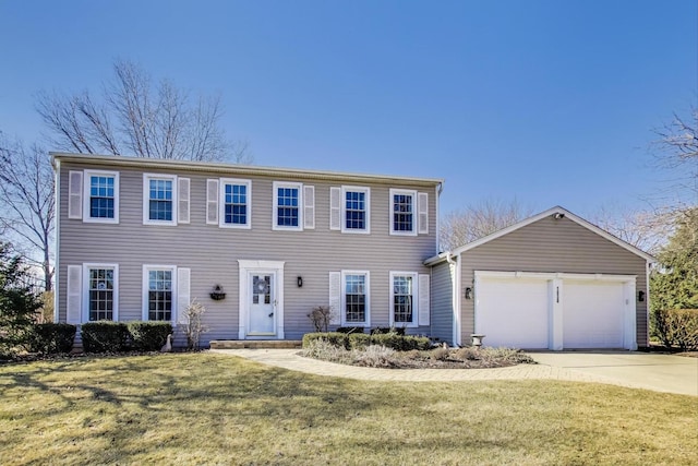 colonial home with driveway, a front yard, and an attached garage