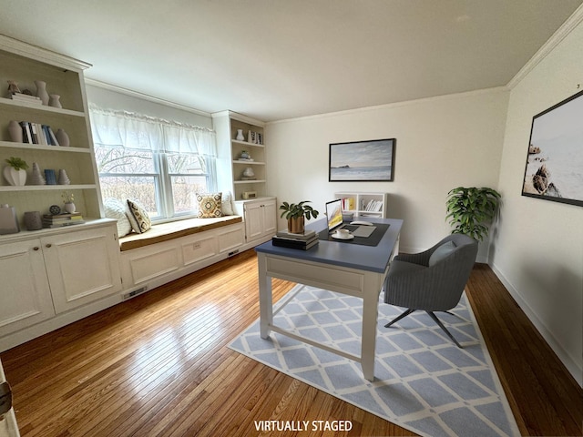 office area featuring visible vents, baseboards, crown molding, and light wood finished floors