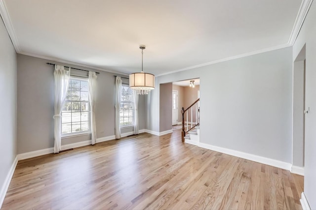 unfurnished dining area featuring light wood finished floors, stairway, baseboards, and ornamental molding