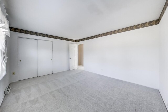 unfurnished bedroom with a closet and carpet floors