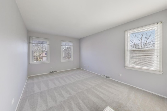 carpeted empty room with baseboards and visible vents