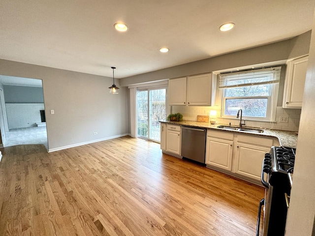 kitchen with range with gas stovetop, white cabinets, dishwasher, and a sink