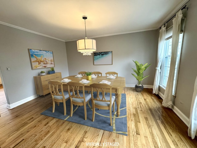 dining space with baseboards, wood finished floors, and crown molding