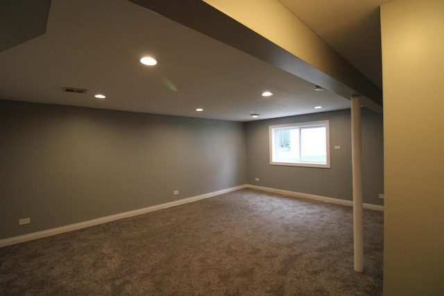 basement with dark colored carpet