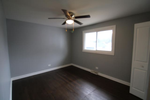 unfurnished room featuring ceiling fan and dark hardwood / wood-style floors