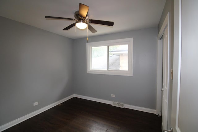 unfurnished bedroom with ceiling fan and dark hardwood / wood-style flooring