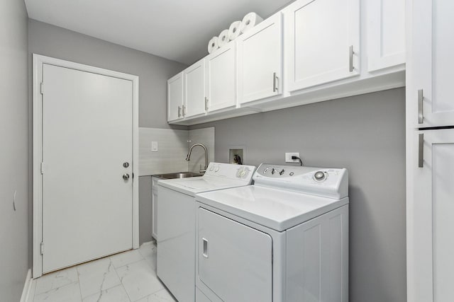 laundry area with independent washer and dryer, cabinets, and sink