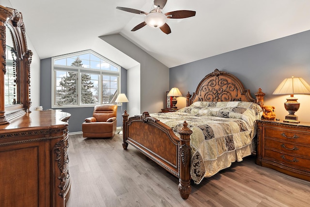 bedroom featuring hardwood / wood-style flooring, vaulted ceiling, and ceiling fan