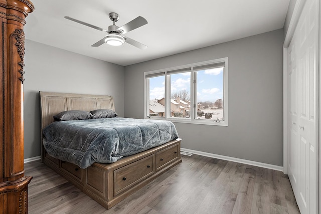 bedroom with ceiling fan, hardwood / wood-style floors, and a closet