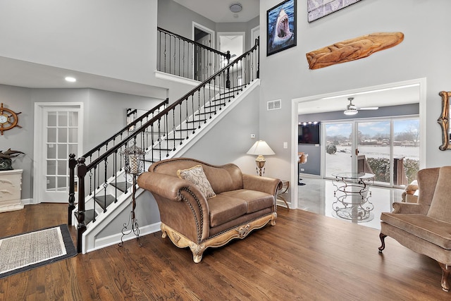 living room featuring ceiling fan and hardwood / wood-style floors