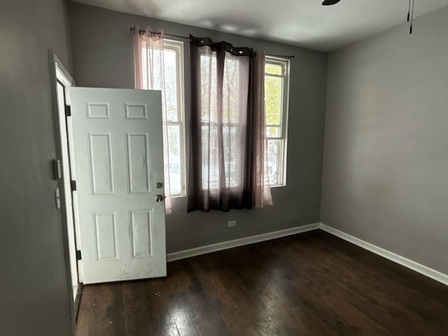 entrance foyer with ceiling fan and dark wood-type flooring