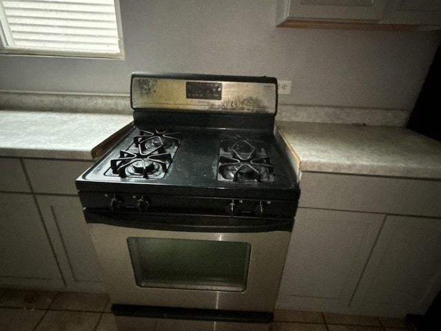 kitchen featuring stainless steel gas stove and light tile patterned floors