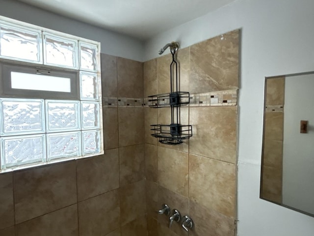 bathroom with a tile shower