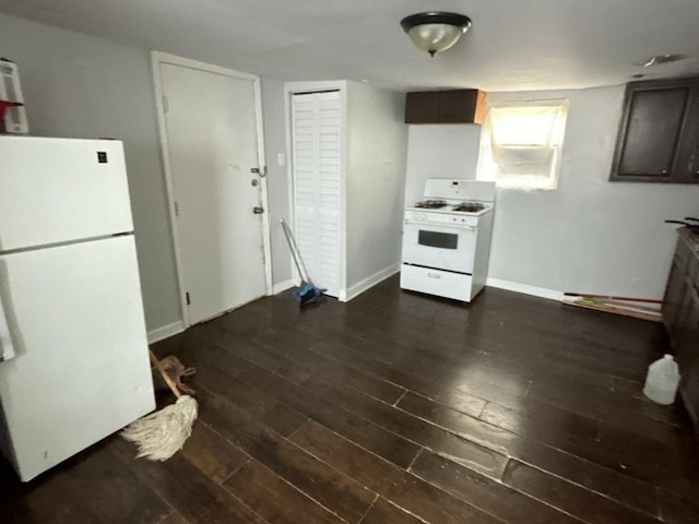 kitchen with white appliances, dark brown cabinetry, and dark hardwood / wood-style flooring