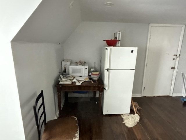 kitchen with white appliances, dark hardwood / wood-style flooring, and lofted ceiling