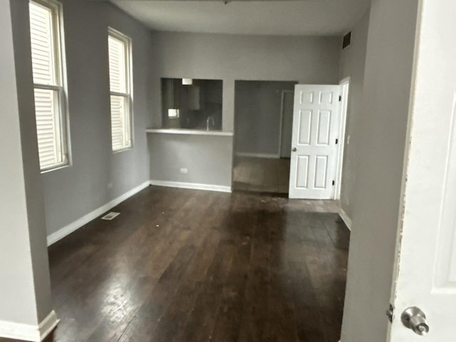 empty room with dark hardwood / wood-style flooring