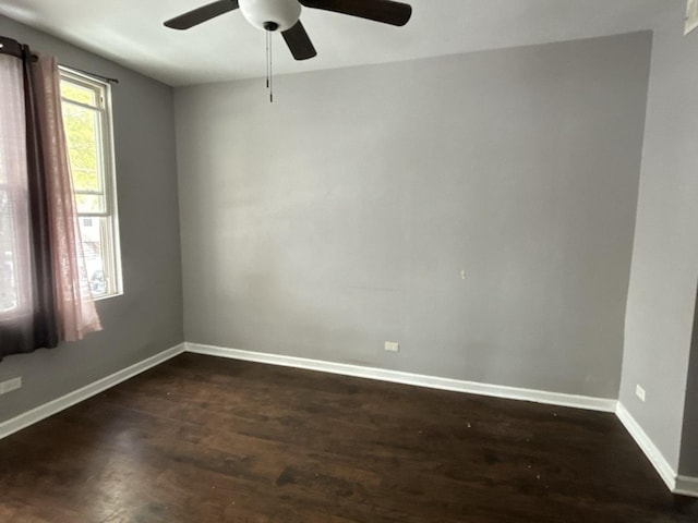 spare room with ceiling fan, dark hardwood / wood-style floors, and a wealth of natural light