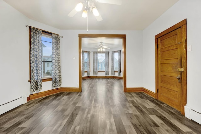 entrance foyer with baseboard heating, dark hardwood / wood-style flooring, and ceiling fan