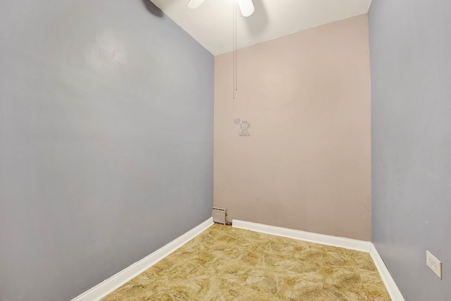 washroom with a baseboard heating unit, ceiling fan, and carpet