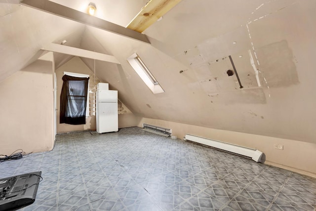 additional living space with a baseboard radiator and vaulted ceiling with skylight