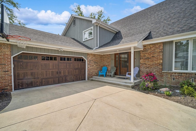 doorway to property featuring a garage and a porch