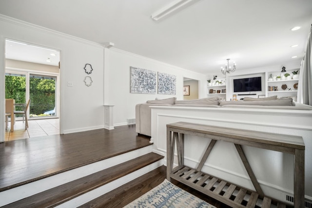 interior space featuring built in features, a chandelier, and dark hardwood / wood-style floors