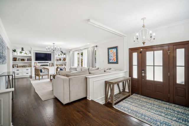 entrance foyer with ornamental molding, dark hardwood / wood-style floors, and a notable chandelier