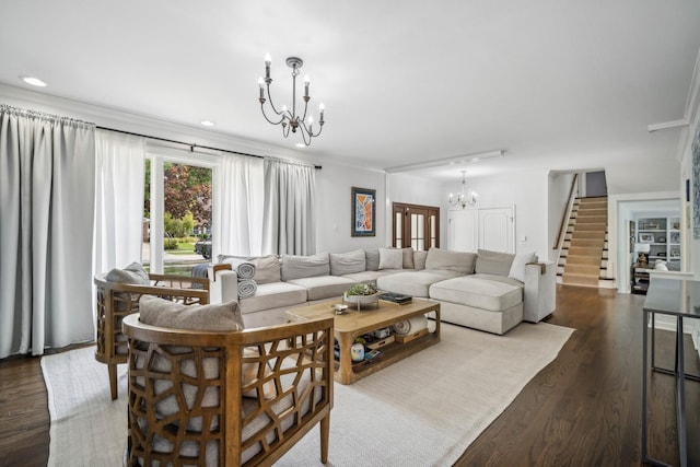 living room with crown molding, dark hardwood / wood-style floors, and a notable chandelier