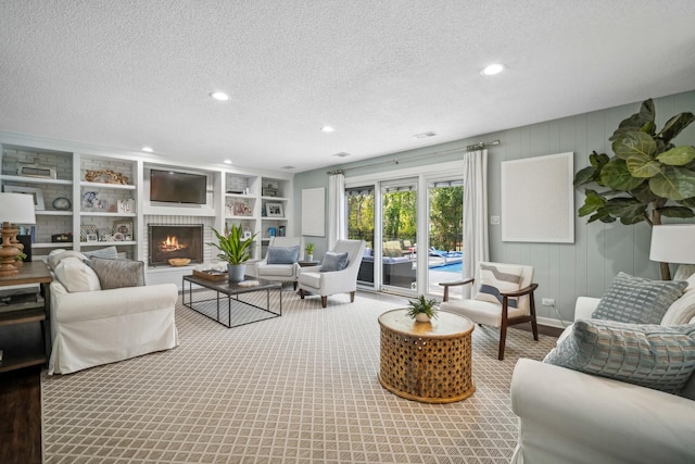 living room with a textured ceiling, a fireplace, and built in features