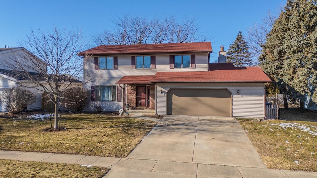 front of property featuring a garage and a front yard