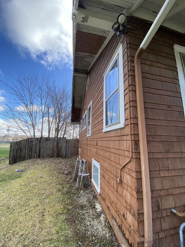 view of side of home featuring a yard