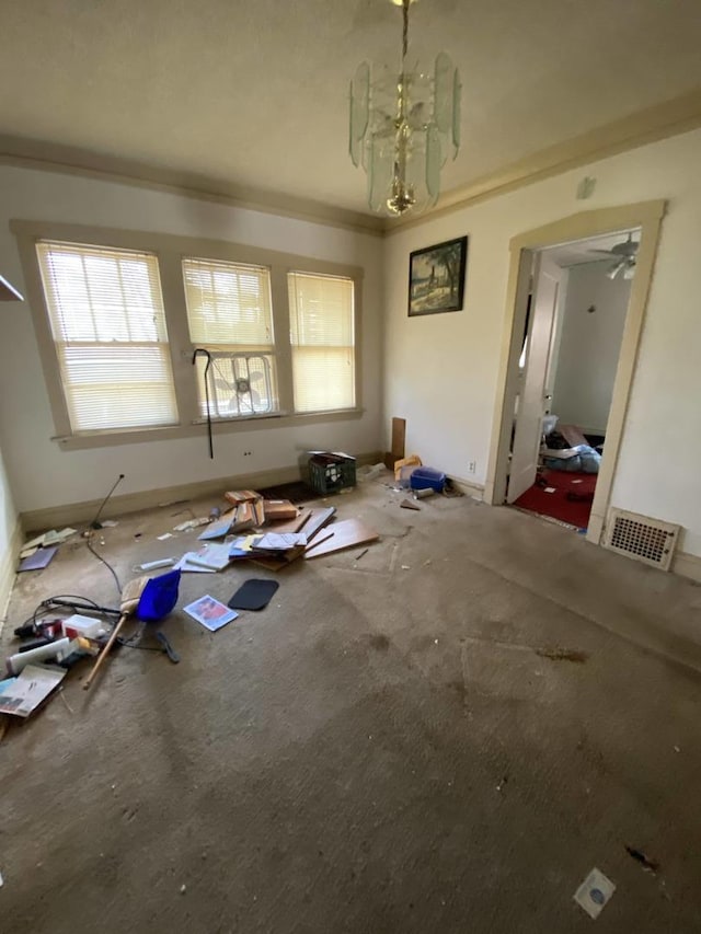 misc room with crown molding and an inviting chandelier