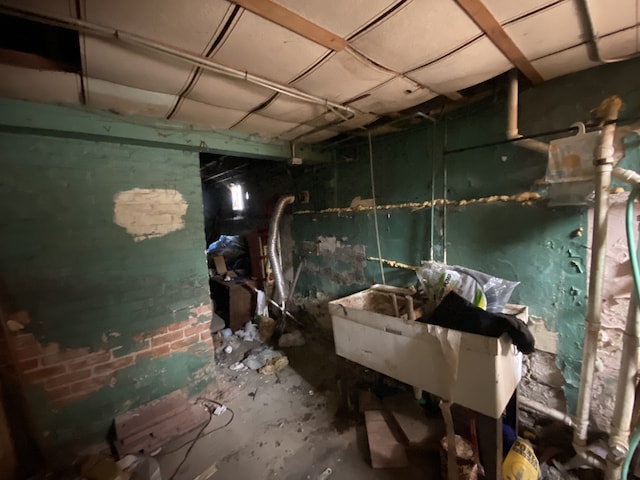 miscellaneous room featuring concrete floors and sink