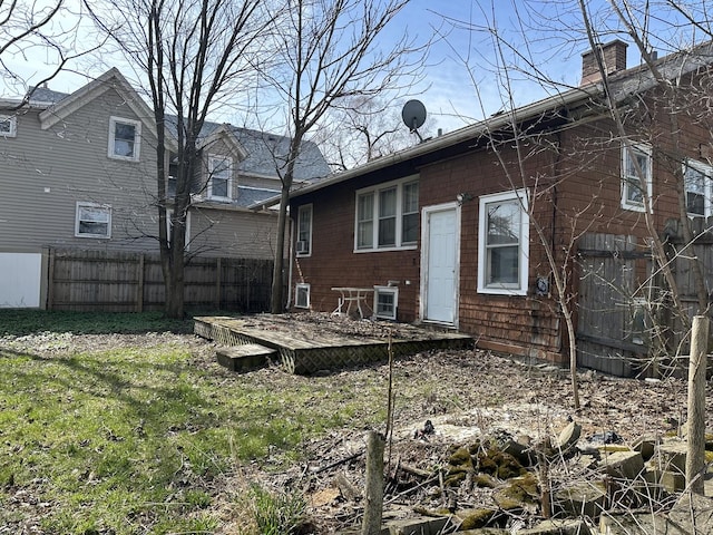 back of house featuring a wooden deck