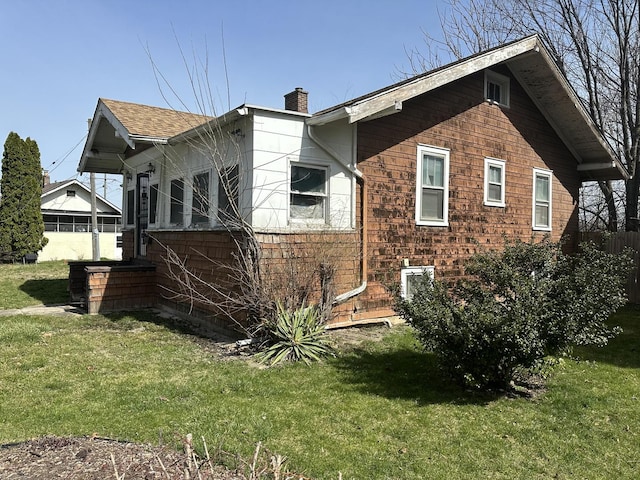 view of side of home with central air condition unit and a yard