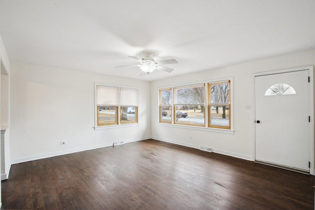 entrance foyer with ceiling fan, dark wood-type flooring, visible vents, and baseboards