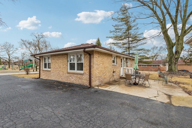 view of home's exterior with a patio and brick siding