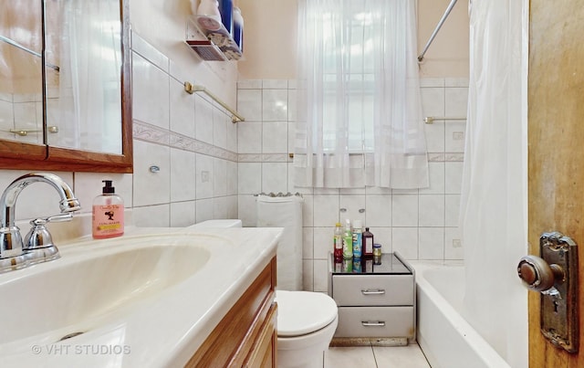 full bathroom featuring tile patterned flooring, tile walls, vanity, shower / bath combination with curtain, and toilet