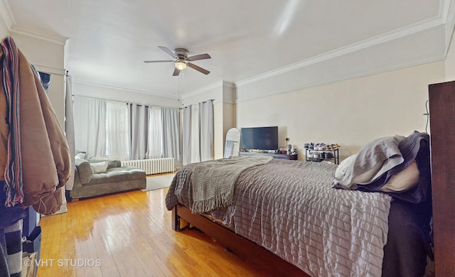 bedroom with ornamental molding, radiator heating unit, light hardwood / wood-style floors, and ceiling fan